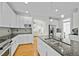 Modern kitchen featuring granite countertops, white cabinets and hardwood floors at 100 Maywood Way, Chapel Hill, NC 27516