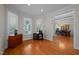 Bright living room with hardwood floors and large windows, seamlessly connecting to the dining area at 100 Maywood Way, Chapel Hill, NC 27516