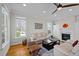 Bright living room features a fireplace, hardwood floors, and neutral paint at 100 Maywood Way, Chapel Hill, NC 27516