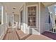 Inviting porch features rocking chairs, shade and natural accents at 100 Maywood Way, Chapel Hill, NC 27516