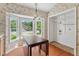 Bright dining area with hardwood floors, a bay window, and a charming light fixture at 1014 Laurens Way, Knightdale, NC 27545