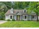 Charming Cape Cod home with dormers and a well-maintained front lawn and mature trees at 1014 Laurens Way, Knightdale, NC 27545