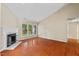 Open living room with fireplace, hardwood floors, natural light, and backyard access at 1014 Laurens Way, Knightdale, NC 27545