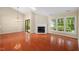 Bright living room with fireplace, hardwood floors, natural light, and sliding glass door at 1014 Laurens Way, Knightdale, NC 27545