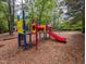 Charming playground set including a colorful slide, climbing structure, and swings at 1014 Laurens Way, Knightdale, NC 27545
