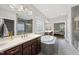 Bright bathroom featuring a large soaking tub, walk in shower, and dual sink vanity at 1029 Dozier Way, Cary, NC 27518