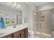 Bathroom featuring a vanity with storage, shower, and natural light at 1029 Dozier Way, Cary, NC 27518