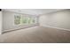 Spacious bedroom features large windows offering great natural light and neutral carpeting at 1029 Dozier Way, Cary, NC 27518
