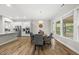 Bright dining room with wood floors, and views to the kitchen and outside at 1029 Dozier Way, Cary, NC 27518