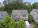 Charming two-story home with trees and a driveway featuring a white trailer for moving at 1029 Dozier Way, Cary, NC 27518