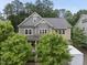 Charming two-story home with trees and a driveway featuring a white trailer for moving at 1029 Dozier Way, Cary, NC 27518