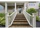 Classic brick front porch and a black front door with white columns and railing at 1029 Dozier Way, Cary, NC 27518