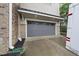 Attached grey two car garage with windows and concrete driveway at 1029 Dozier Way, Cary, NC 27518