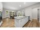 Bright kitchen featuring a large island, stainless appliances, and an adjacent dining area at 1029 Dozier Way, Cary, NC 27518