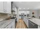 Modern kitchen featuring granite countertops, stainless steel appliances, and hardwood floors at 1029 Dozier Way, Cary, NC 27518