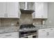 Modern kitchen features stainless steel appliances, stone backsplash, and granite countertops at 1029 Dozier Way, Cary, NC 27518