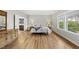 Bright main bedroom featuring hardwood floors, ensuite bathroom, and a large window at 1029 Dozier Way, Cary, NC 27518