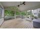 Inviting screened porch with wood flooring, ceiling fans and backyard views at 1029 Dozier Way, Cary, NC 27518