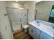 Bright bathroom featuring a shower, toilet, and sink with modern fixtures and a white cabinet at 10517 Brookside Reserve Rd, Raleigh, NC 27614