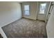 A carpeted bedroom with neutral walls and natural light coming through a window at 10517 Brookside Reserve Rd, Raleigh, NC 27614