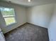Cozy carpeted bedroom with a view of the greenery outside at 10517 Brookside Reserve Rd, Raleigh, NC 27614