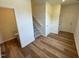 Inviting entryway with wood floors, a staircase, a storage closet, and natural light at 10517 Brookside Reserve Rd, Raleigh, NC 27614