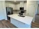 Well-equipped kitchen with stainless steel appliances, an island, and white cabinetry at 10517 Brookside Reserve Rd, Raleigh, NC 27614