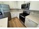 Modern kitchen featuring stainless steel appliances, white cabinets, and sleek countertops at 10517 Brookside Reserve Rd, Raleigh, NC 27614