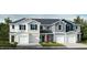 Charming townhome exteriors showcase varied colors and attached garages for a modern look at 10564 Brookside Reserve St, Raleigh, NC 27614