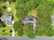 Aerial view showcasing the layout of the home, driveway, and surrounding trees in a private setting at 106 Eagle Crest Ln, Princeton, NC 27569