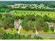 Expansive aerial view of a property featuring a well-manicured lawn, mature trees, and a long driveway at 106 Eagle Crest Ln, Princeton, NC 27569