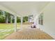 Covered back porch with a light wood floor and view of the backyard at 106 Eagle Crest Ln, Princeton, NC 27569