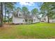 Lovely home showcasing a lush green backyard with ample space and a charming covered porch for relaxation at 106 Eagle Crest Ln, Princeton, NC 27569