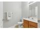 Bathroom featuring single sink vanity, a white toilet, and neutral tile flooring at 106 Eagle Crest Ln, Princeton, NC 27569