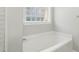Soaking tub with decorative glass block window at 106 Eagle Crest Ln, Princeton, NC 27569