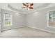Spacious bedroom featuring plush carpeting, tray ceiling with fan, and lots of natural light at 106 Eagle Crest Ln, Princeton, NC 27569