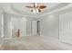 Bright bedroom featuring plush carpeting, ensuite bathroom, and walk-in closet at 106 Eagle Crest Ln, Princeton, NC 27569