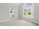 Bedroom features neutral carpet, a built-in bookshelf, and a large window with natural light at 106 Eagle Crest Ln, Princeton, NC 27569