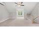 A carpeted bonus room with two large windows, a ceiling fan, and a cooling system at 106 Eagle Crest Ln, Princeton, NC 27569