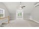 A carpeted bonus room with two large windows, a ceiling fan, and a cooling system at 106 Eagle Crest Ln, Princeton, NC 27569