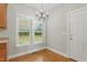 Bright dining area features hardwood floors, natural light, and decorative chandelier at 106 Eagle Crest Ln, Princeton, NC 27569