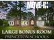 Charming single-Gathering home featuring brick and white siding, a welcoming porch, and a well-manicured front lawn at 106 Eagle Crest Ln, Princeton, NC 27569