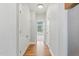 Bright hallway with hardwood floors, closet and a window at the end at 106 Eagle Crest Ln, Princeton, NC 27569