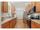 Kitchen with wood cabinets, stainless steel appliances, and hardwood floors at 106 Eagle Crest Ln, Princeton, NC 27569