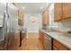 Well-lit kitchen featuring stainless steel appliances, hardwood floors and light wood cabinets at 106 Eagle Crest Ln, Princeton, NC 27569