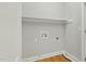 Minimalist laundry room with hardwood floors and simple fixtures at 106 Eagle Crest Ln, Princeton, NC 27569