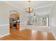 Open living room area next to the kitchen, featuring wood floors, a ceiling fan, and natural light at 106 Eagle Crest Ln, Princeton, NC 27569
