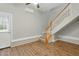 The living room has hardwood floors, a staircase, cooling system, and an exterior door at 106 Eagle Crest Ln, Princeton, NC 27569