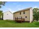 Expansive backyard view featuring a wooden deck, lush green lawn, and exterior of the home at 107 Kimeo Way, Garner, NC 27529