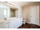 Bathroom features double sinks, white cabinets, and wood-look flooring at 107 Kimeo Way, Garner, NC 27529